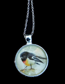 small pendant with a bird on it